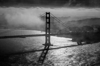 Black and white Golden Gate Bridge on a foggy morning.