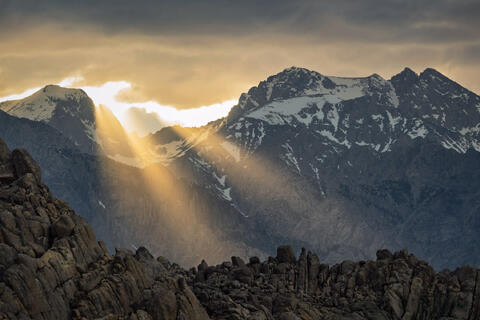Eastern Sierra Nevada mountains in California with snow-covered peaks and Alabama Hills rocky foreground
