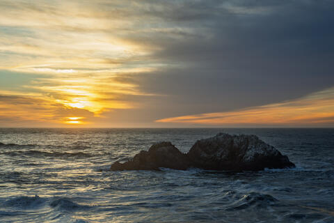 Lands End in San Francisco with a single sea stack and sunset light over the Pacific Ocean