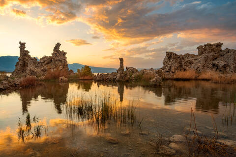 Mono Lake in California at sunset with tufa towers reflected in still water