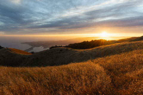 Mount Tamalpais in Marin County at sunset with golden hills and distant bay visible