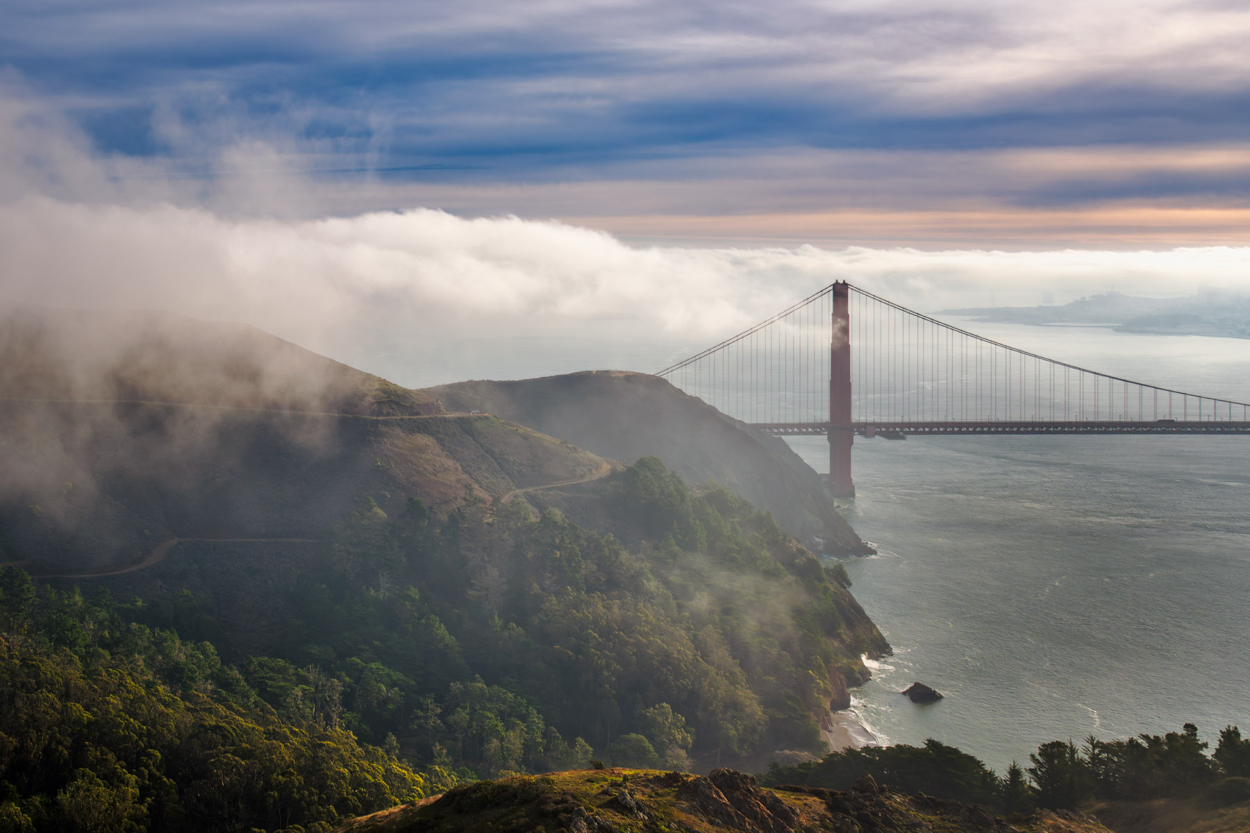 Westside Groove Golden Gate Bridge viewed from the Marin Headlands with coastal cliffs, fog, and ocean below
