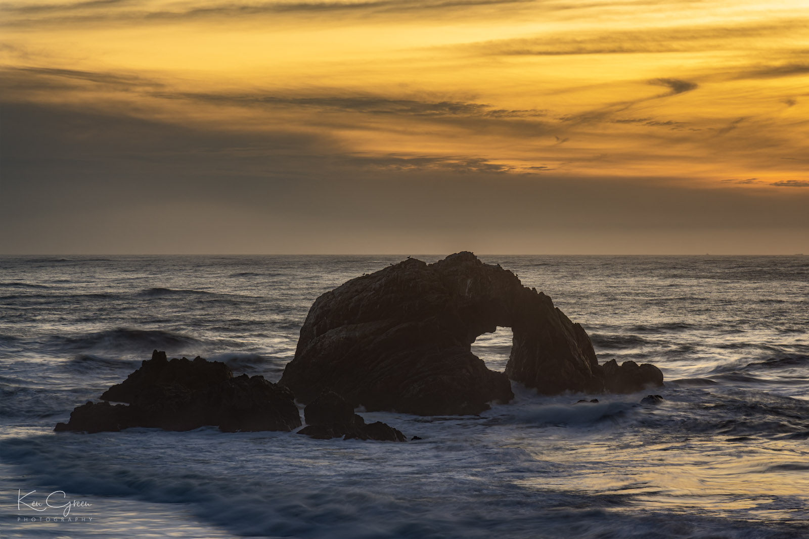 Sea stack near Land's End on San Francisco shore at sunset 
