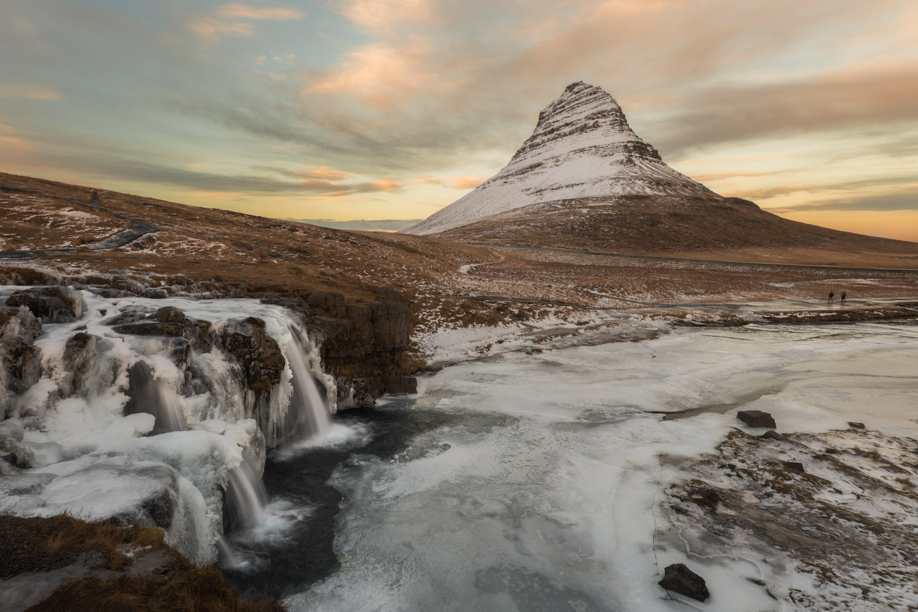 Simple Pleasures Mount Kirkjufell in Iceland with icy waterfalls and snow-covered ground in the foreground