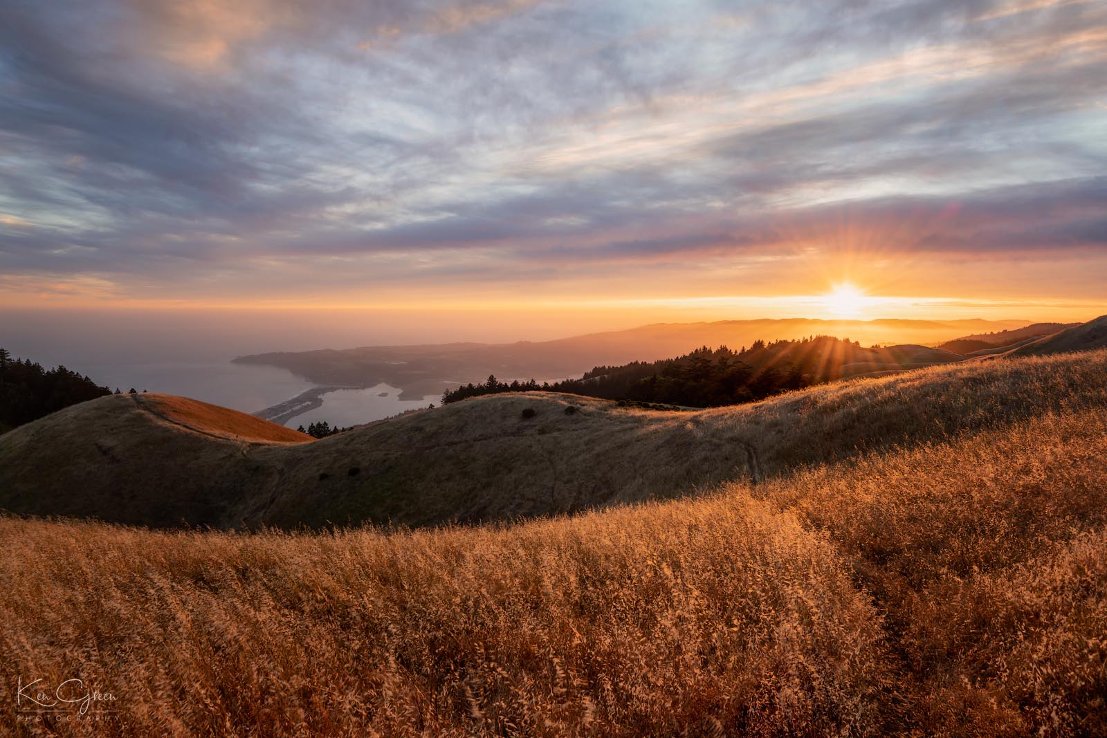 A view of the sun setting over the Pacific Ocean from the peak of Mount Tamalpais in Marin County, California.