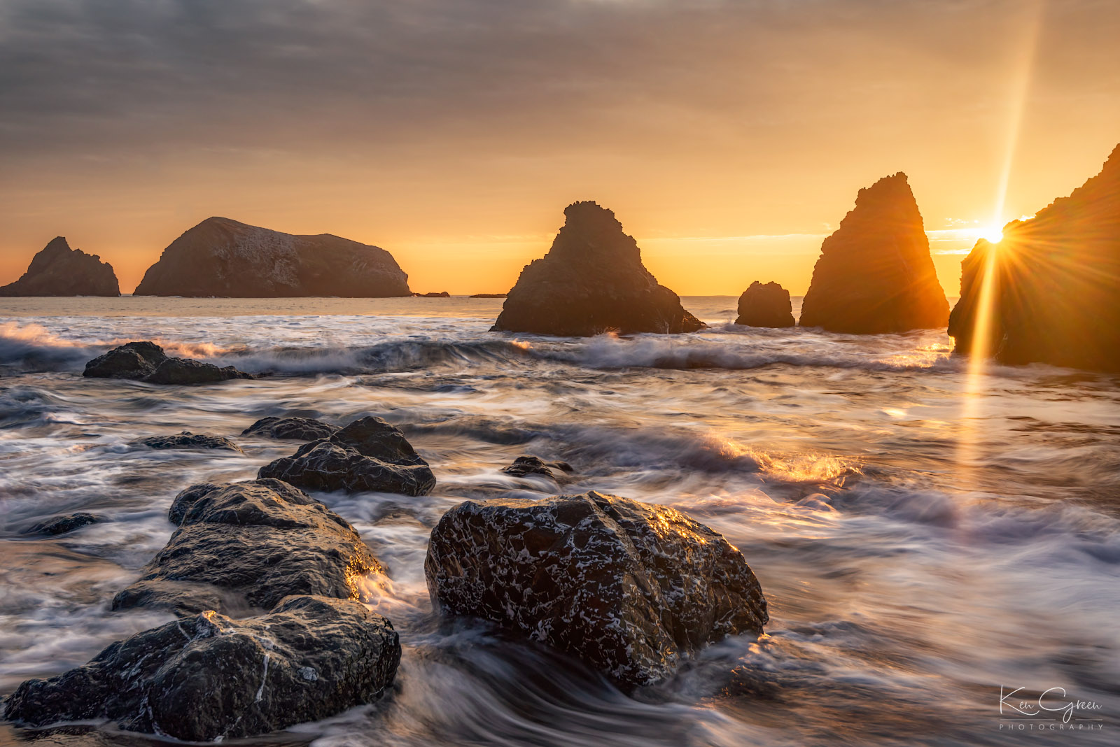 Sea stacks, beach rocks and sunset at Rodeo Beach in Sausalito, California.