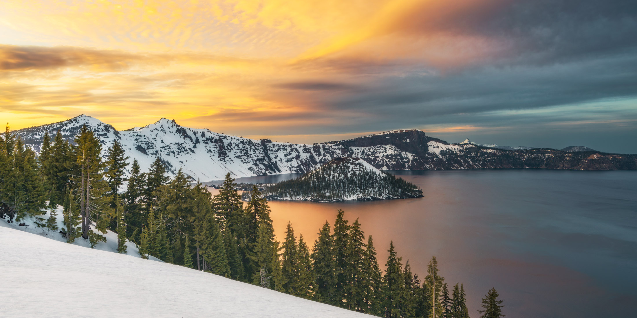 Sweeping photo of Crater Lake and Wizard Island at sunset
